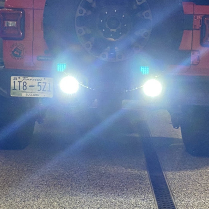 Close-up on the bumper of a Jeep Wrangler JL with Rear Bumper LED Reverse Lights installed, and turned on.