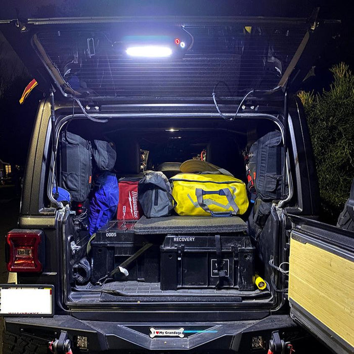 Rear end of a Jeep with Cargo LED Light Module installed, illuminating the rear cargo area.