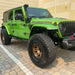 Three quarters view of a green Jeep Wrangler JL with Sidetrack™ LED Lighting System installed.