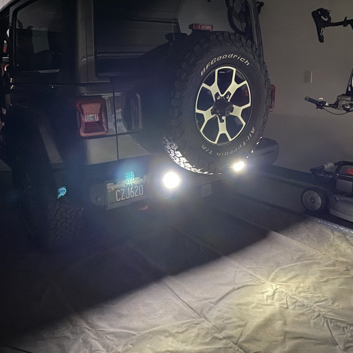 Rear end of a Jeep Wrangler JL with bright reverse lights turned on.