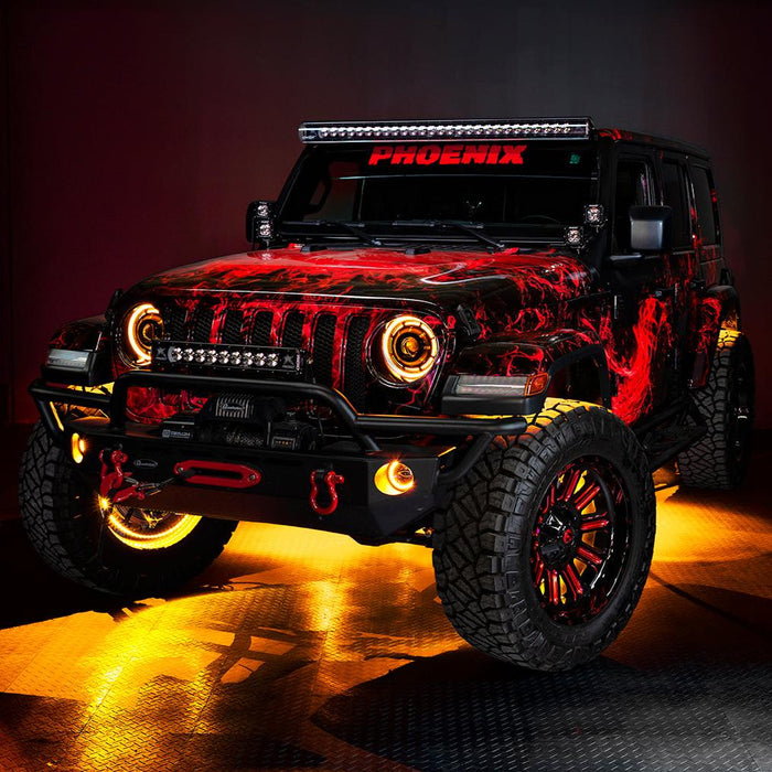 Three quarters view of a red Jeep Wrangler JL, with ColorSHIFT Oculus Headlights, and amber halo rings.