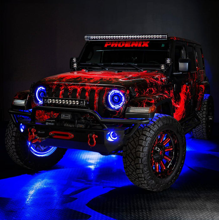 Three quarters view of a red Jeep Wrangler JL with High Performance 20W LED Fog Lights installed, and blue halos on.