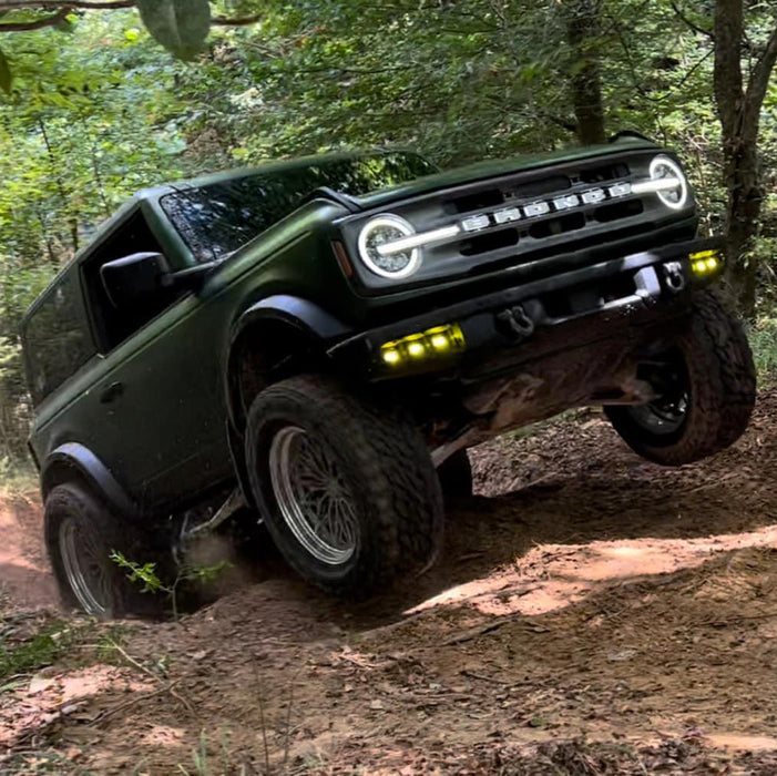 Ford Bronco riding on a trail with multiple LED lighting products installed.