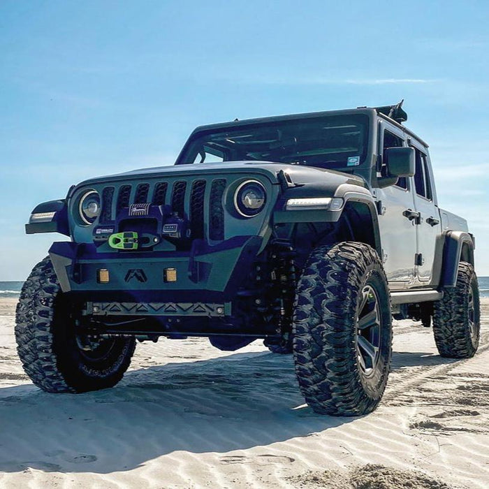 Three quarters view of a Jeep Gladiator JT on the beach, with Oculus Headlights installed.