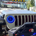 Front end of a Jeep with ColorSHIFT Oculus Headlights installed, with blue halos on.