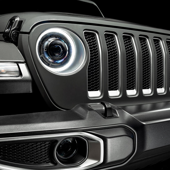 Close-up on the front end of a Jeep Wrangler with Oculus Headlights installed, with white LED halos.