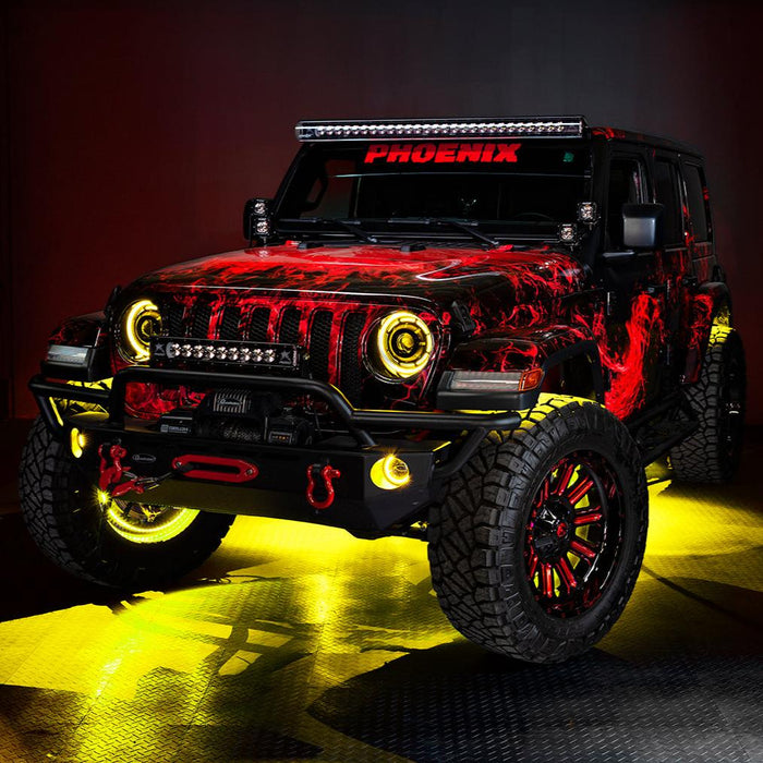 Three quarters view of a red Jeep Wrangler JL, with ColorSHIFT Oculus Headlights, and yellow halo rings.