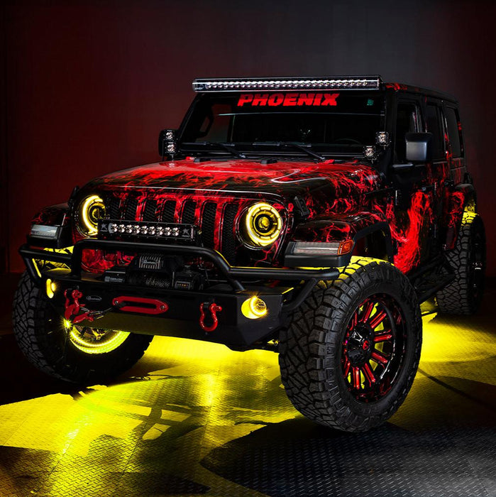 Three quarters view of a red Jeep Wrangler JL with High Performance 20W LED Fog Lights installed, and yellow halos on.